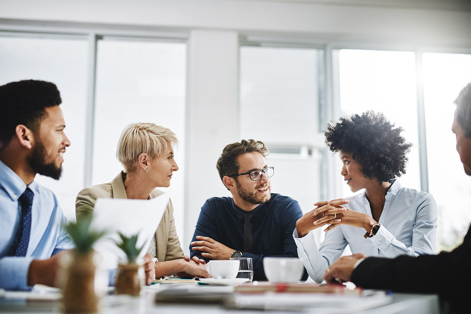 Diverse group of people are a desk