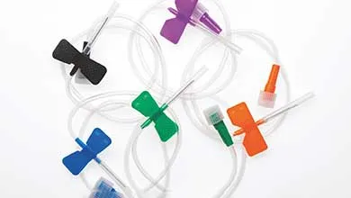 Assorted butterfly needles with black, blue, green, orange, and purple wings on a white background.