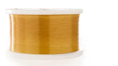 A white plastic spool tightly wound with golden-yellow thread or wire on a plain white background.