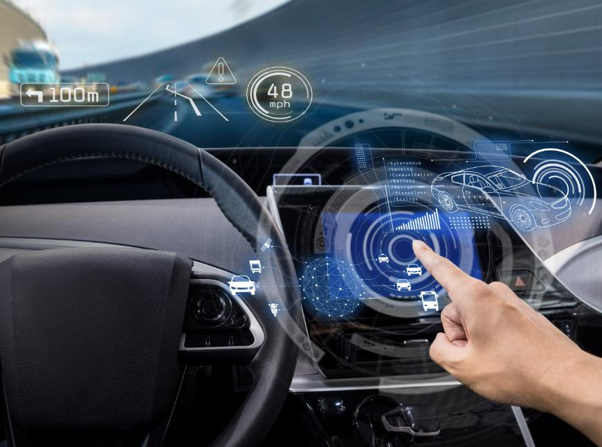 A hand uses a holographic car dashboard display showing speed, navigation, and nearby vehicles.